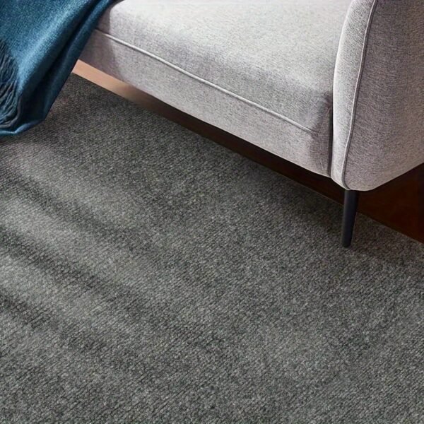 A Roll of Area Rug Featuring Peel-And-Stick Carpeting That Has a Self-Adhesive, Non-Slip Surface